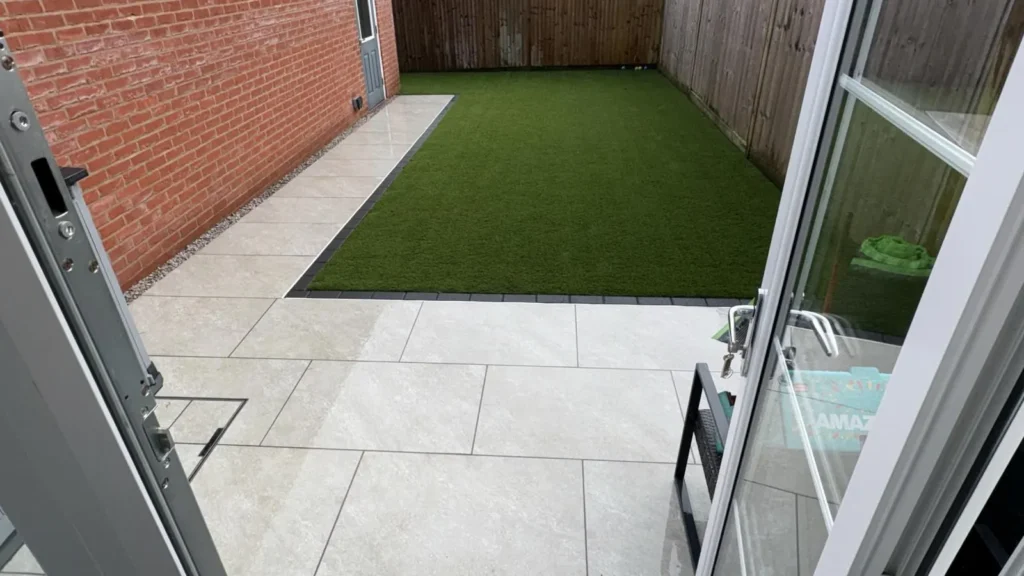 Artificial grass with porcelain paving border