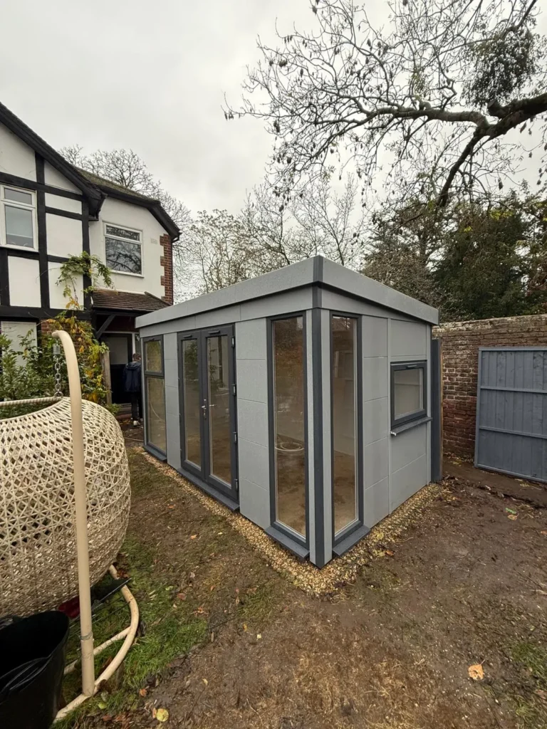 Garden room installed in a landscaped garden