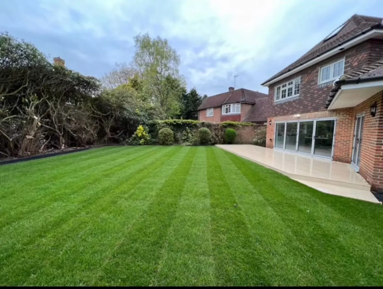 Newly laid striped lawn and patio after landscaping