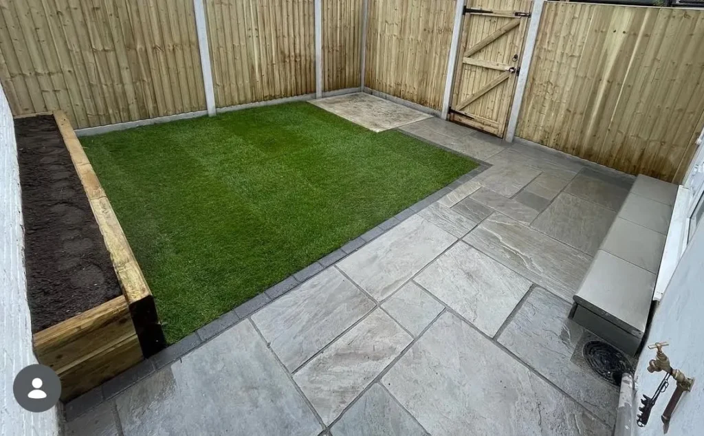 Grey porcelain patio with artificial grass and new fence